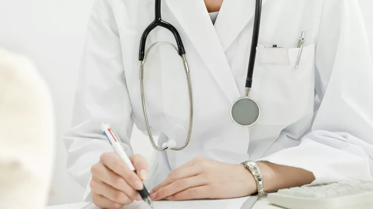 The doctor who fills out a medical record