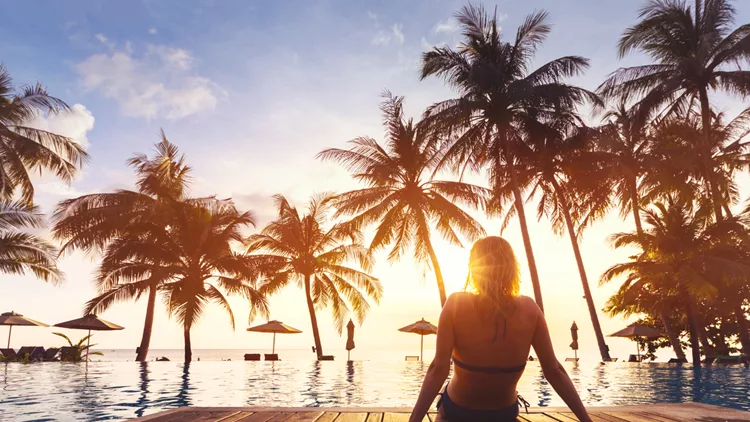 Woman enjoying vacation holidays luxurious beachfront hotel resort swimming pool