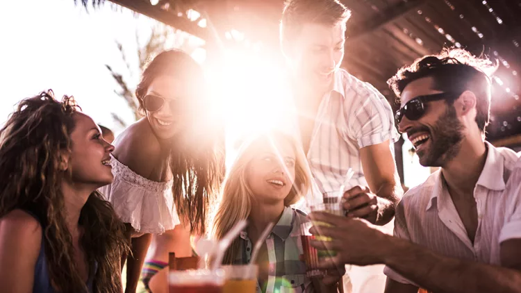 Young happy people enjoying a day in a bar.