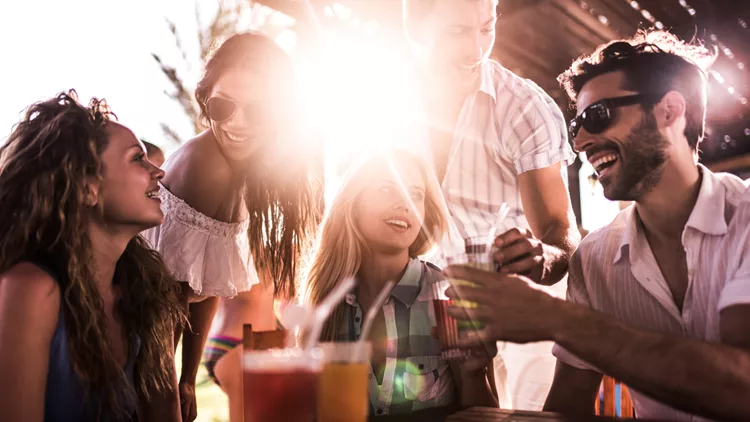 Young happy people enjoying a day in a bar.