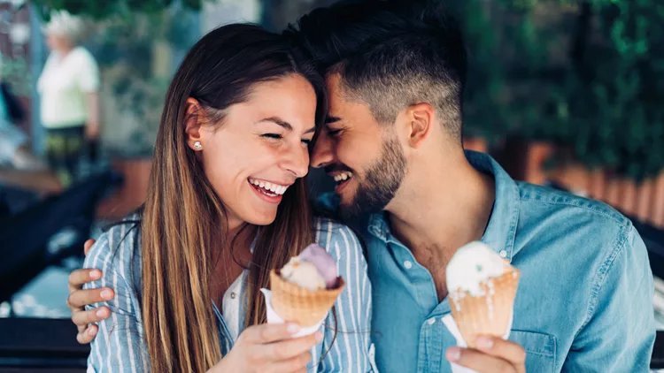 Happy couple having date and eating ice cream