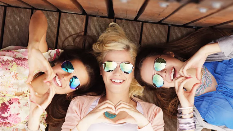 Group of happy friends showing hearts