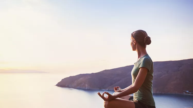 Harmony. Young woman meditating outdoors