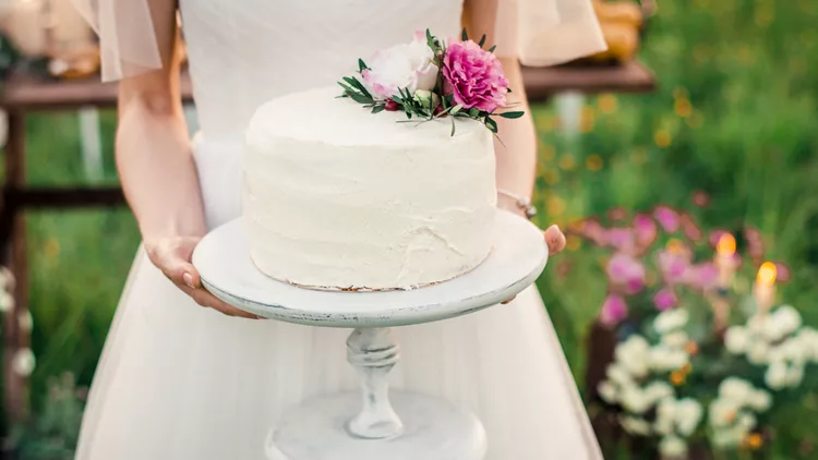Wedding cake in brides hands