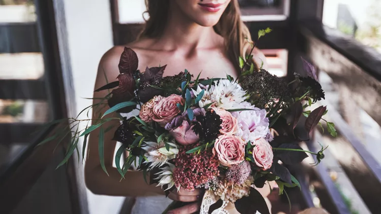 luxurious bouquet in bride's hands. Rustic style in dark tones
