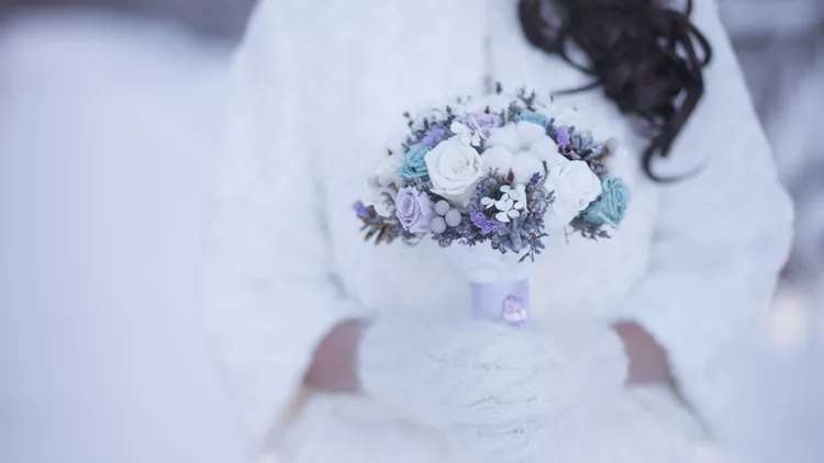 Bride on wedding holding beautiful flower bouquet