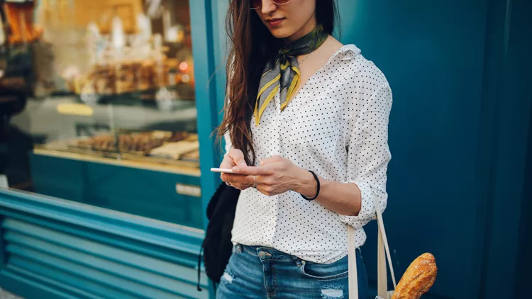 Young Parisian woman using the smartphone