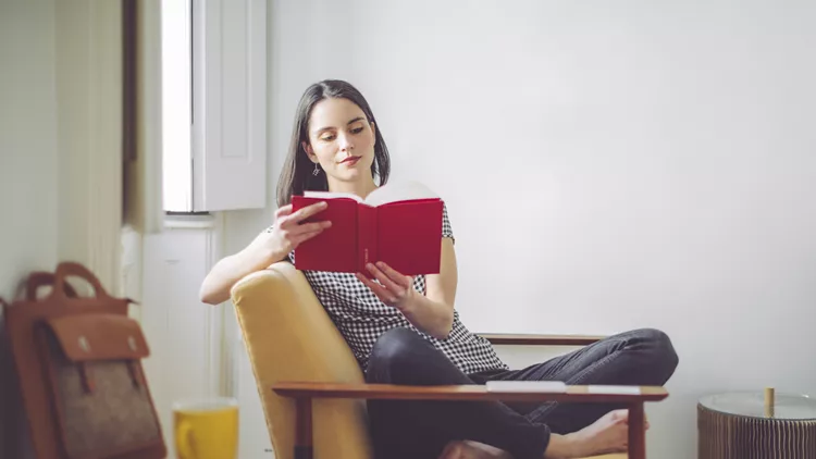 Young woman reading at home