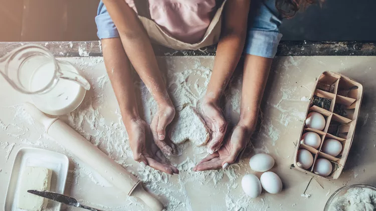 Mom with daughter on kitchen.