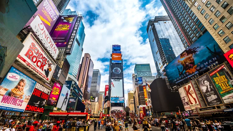 Busy Times Square in NYC. The place is famous as world's busiest place for pedestrians and an iconic landmark for thousands of tourists in Manhattan.