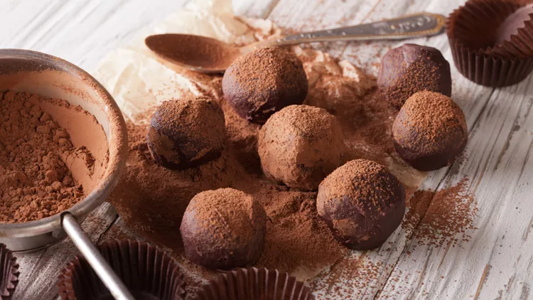 chocolate truffles sprinkled with cocoa powder close-up