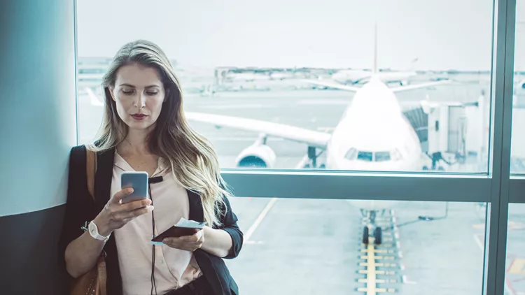 Checking her boarding schedule