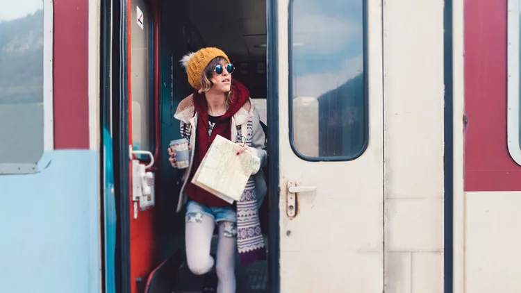 Teenage girl getting out of the train