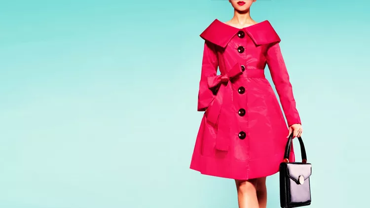 Red coat woman with black leather handbag. Beautiful vintage style.