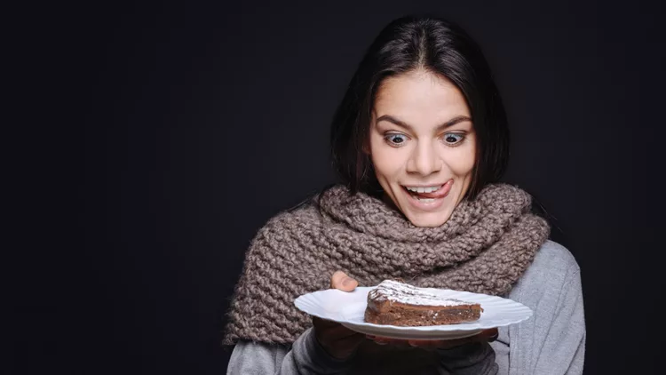 Joyful woman going to eat the piece of cake