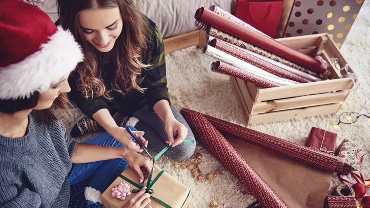 Girls  preparing a present for christmas