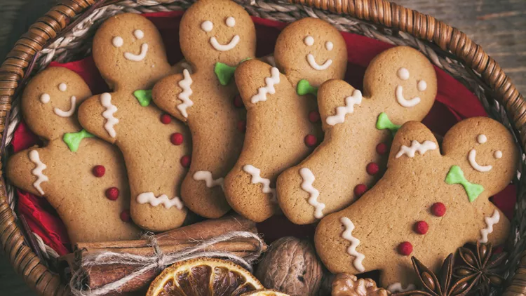 Christmas gingerbread man cookies on a wooden table.