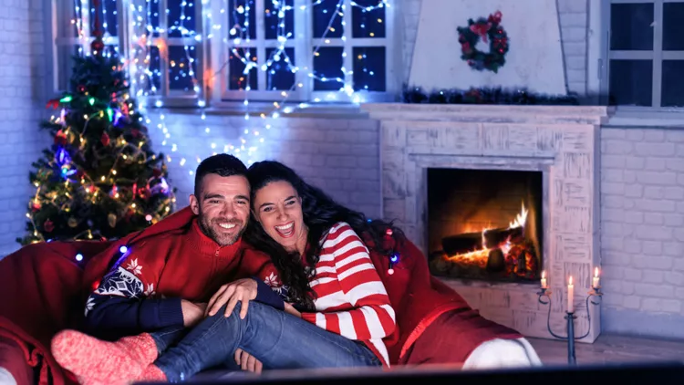 Couple watching TV at home