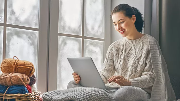 woman sitting near windows