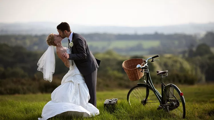 Newlyweds embracing and kissing each other.