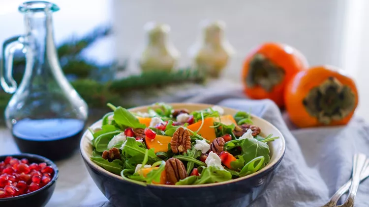 Fresh salad with fruits and greens.