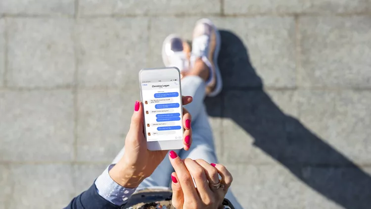 Woman using instant messaging app on mobile phone