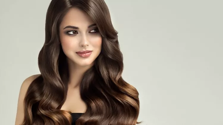Young, brown haired beautiful model with long,curly, well groomed hair. Excellent hair waves.