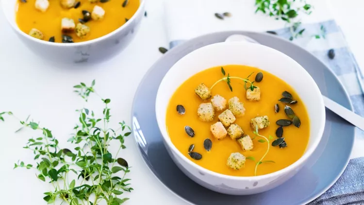 pumpkin-soup-served-with-croutons-and-pumpkin-seeds-picture-id607498822
