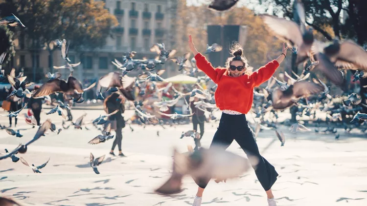 Girl jumping from joy in Barcelona