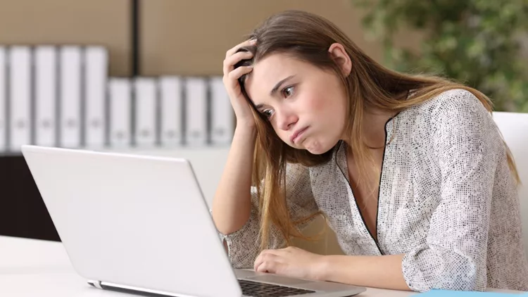 frustrated-intern-working-on-line-at-office-picture-id647280958