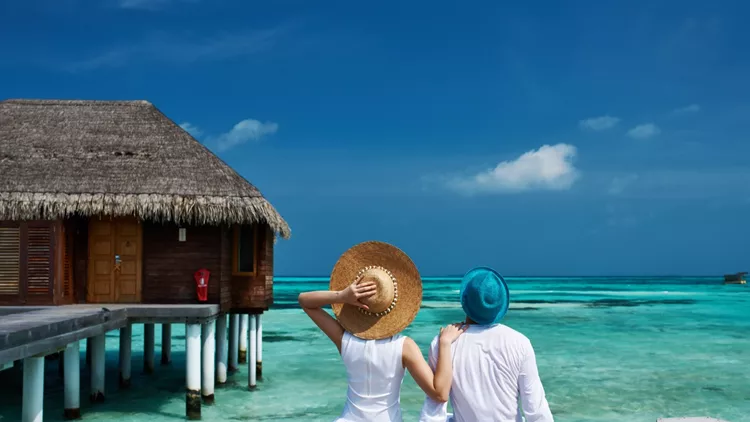 Couple on a beach jetty at Maldives