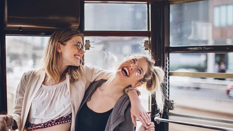 Happy girls hugging in tramcar