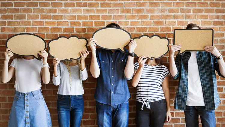 Young adults holding up copy-space placard thought bubbles