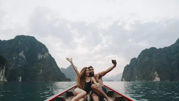 Couple taking selfie on a longtail boat