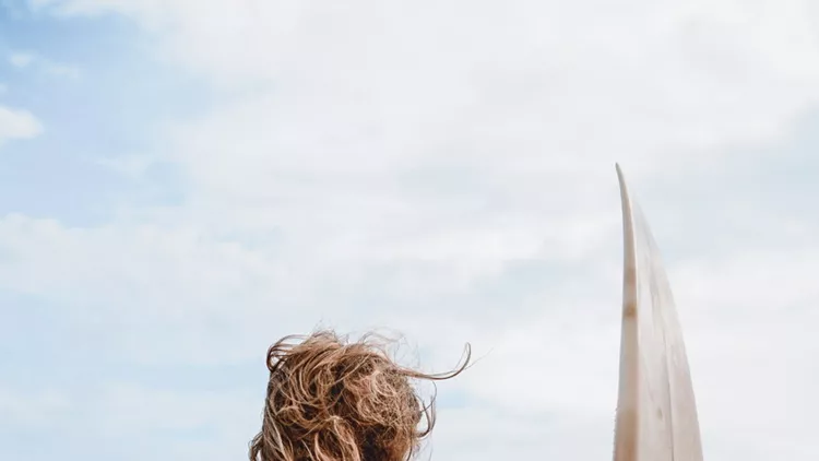 Attractive Female Waiting For Surfing Waves On Beach