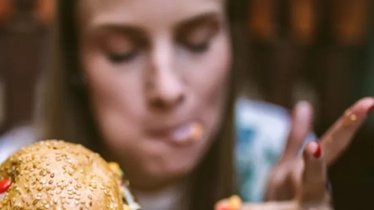 woman-enjoying-delicious-burger-picture-id1055590912-1-600x600