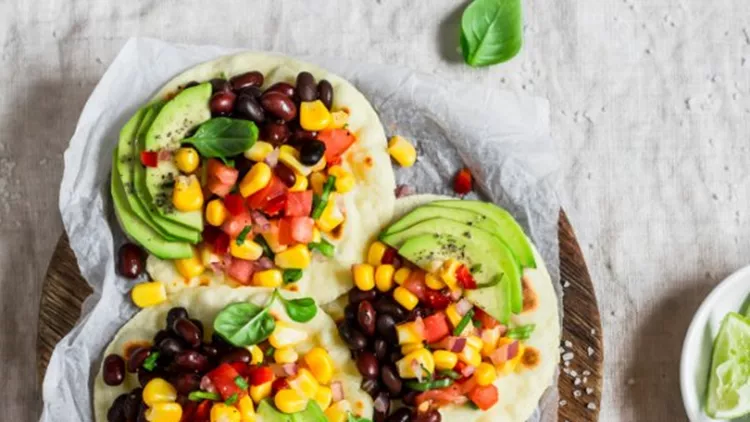 spicy-bean-tortillas-with-corn-salsa-and-avocado-picture-id622442874-600x600