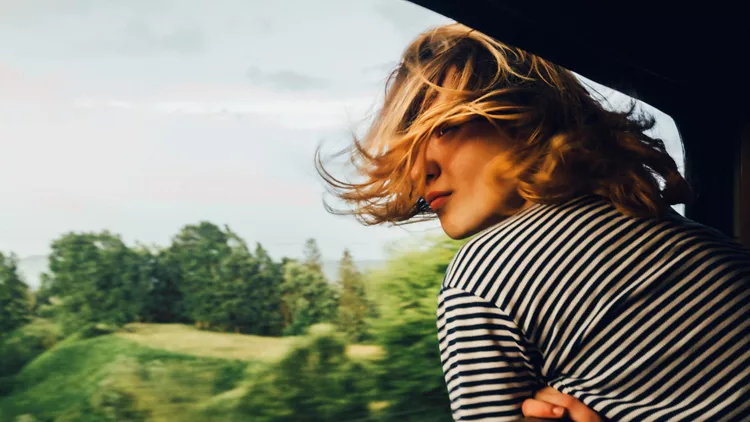 Woman looking at the view from train