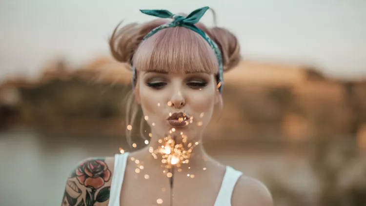 Happy girl holding burning sparklers