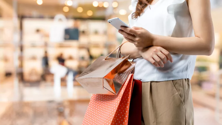 shopping concept. woman using smart phone with shopping bag.