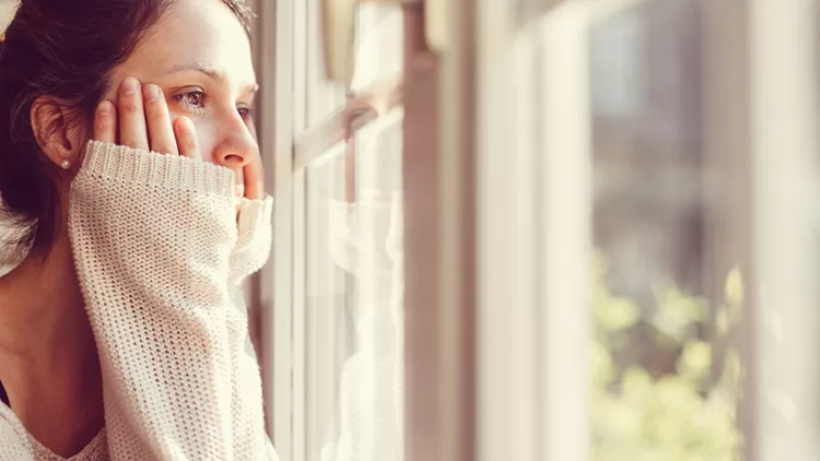 Girl looking through the window