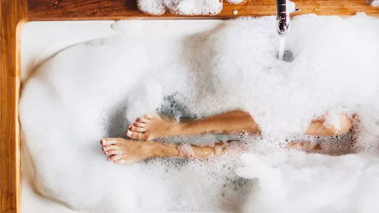 woman-legs-in-bath-foam-top-view-enjoying-and-relaxation-in-spa-hotel-picture-id997513944