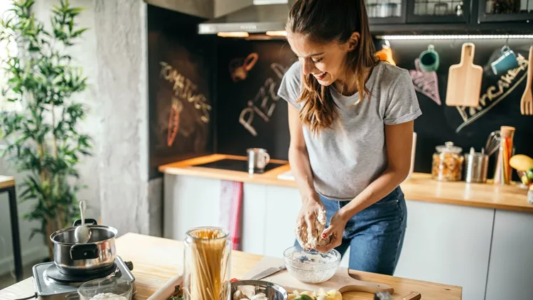 Young woman preparing pizza