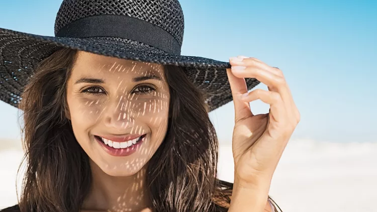 Woman wearing black hat at beach