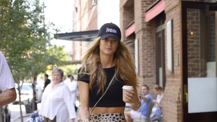 Kate Bock Wears A Cropped Top, Leopard Skirt, White Nike Sneakers And YSL Cross-body Bag While Walking Her Dog