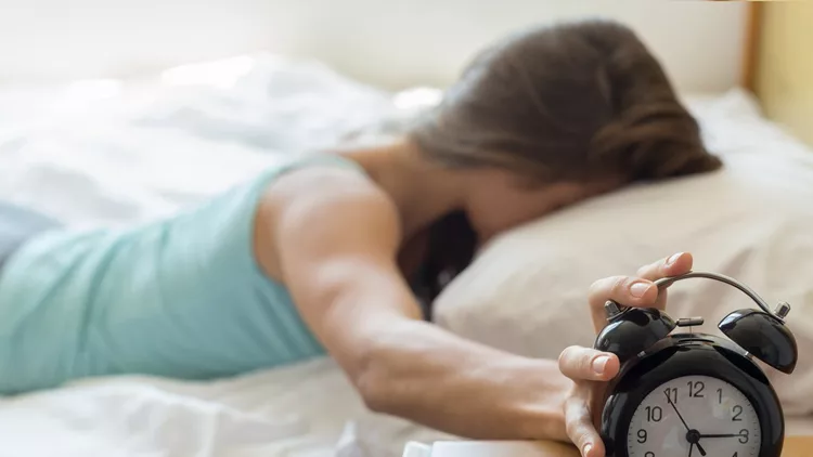 Wake up of a girl stopping alarm clock