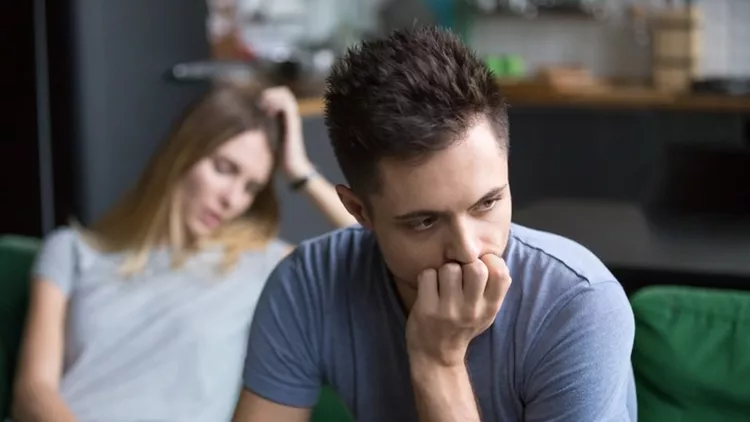 Upset boyfriend thinking of family conflicts after fight with girlfriend