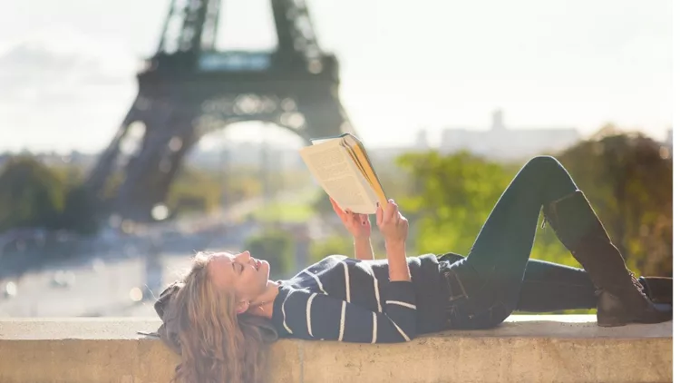 girl-reading-book-in-paris-on-a-sunny-day-picture-id465202415(1)