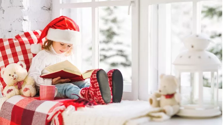 happy-child-reading-a-book-while-at-a-winter-window-picture-id627164012(1)
