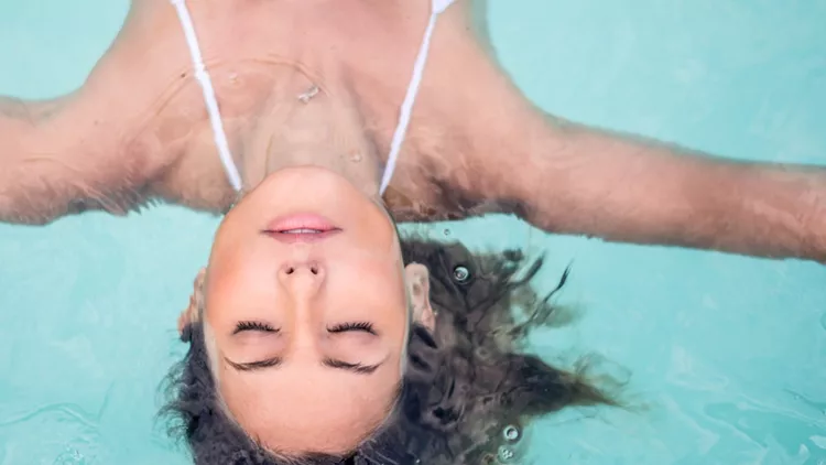 Woman relaxing in the swimming pool